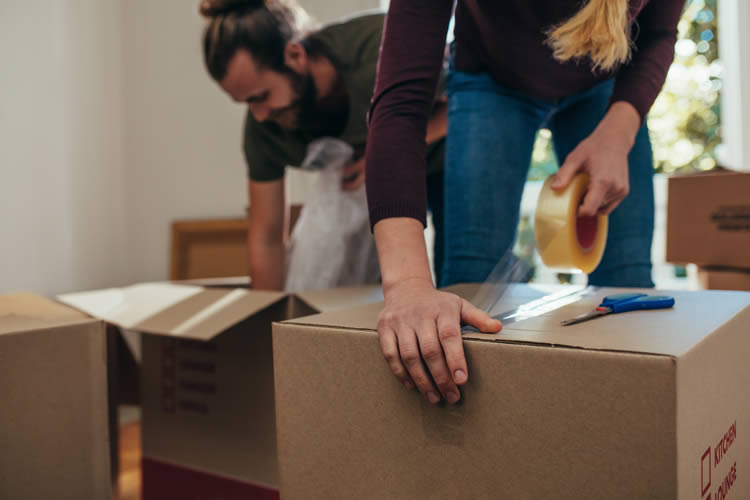 couple packing their boxes before moving home