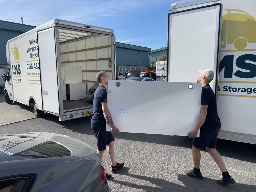 removal team moving a desk for an office removal