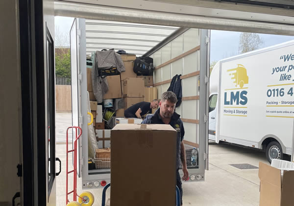 removal van being loaded with packed boxes