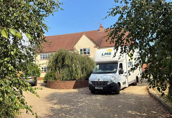 removal van parked next to large house