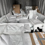 furniture items carefully wrapped and packaged ready for moving in the back of a lorry